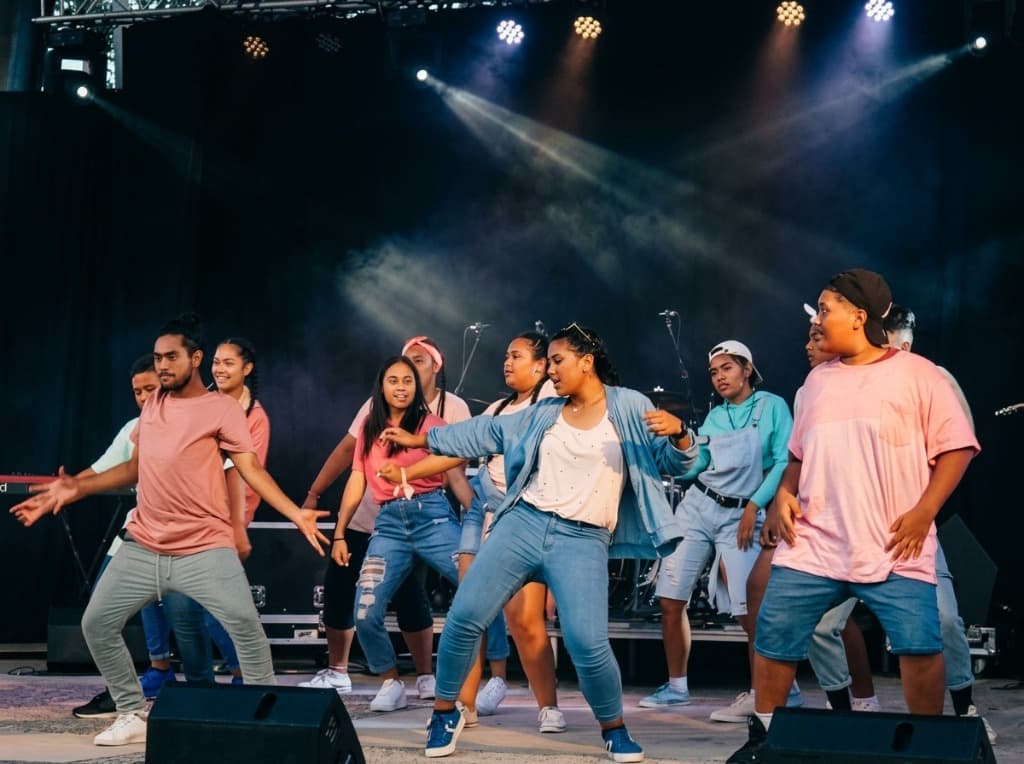 Energetic high school youth dancers performing live on stage at Bring It On festival